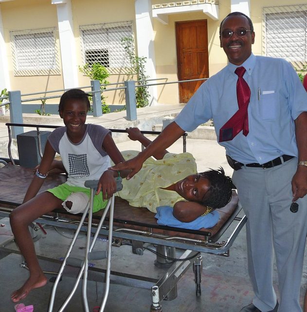 Dr. Leger with his first amputee patient and her adopted sister